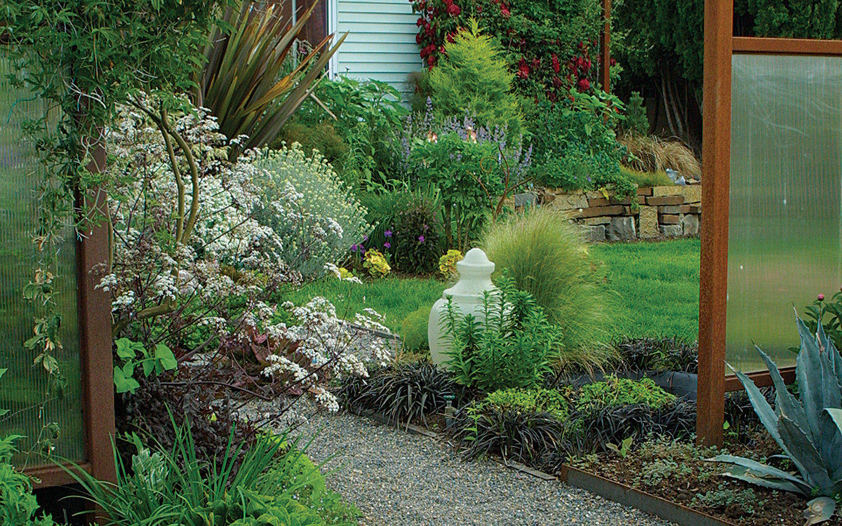 At the main entrance to author's front garden an opening in a fabricated steel fence focuses attention on the scene it frames.