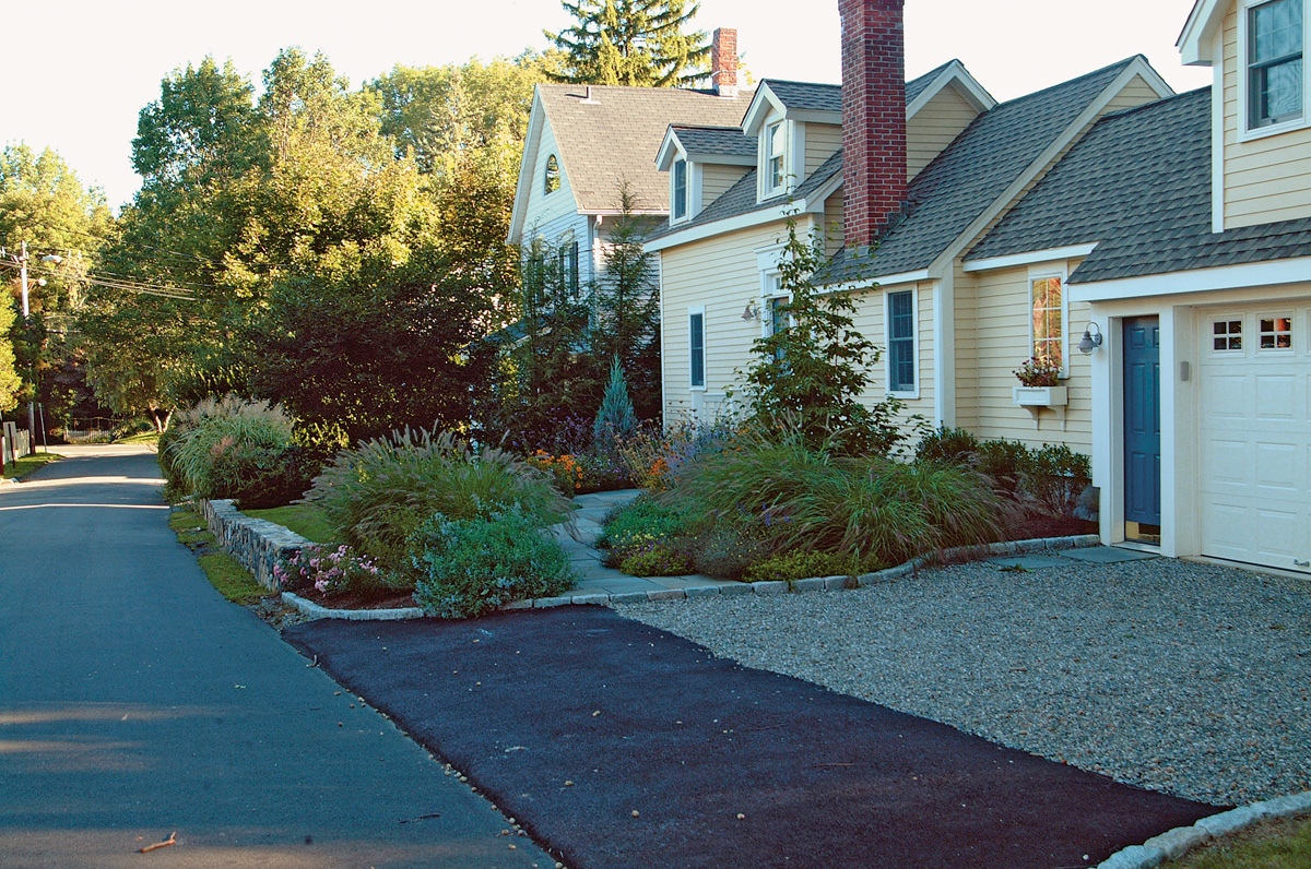 driveway with plants lining the side