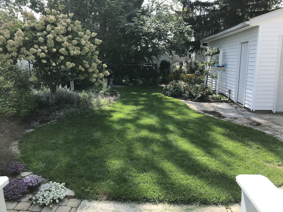 view of gardens around a small lawn