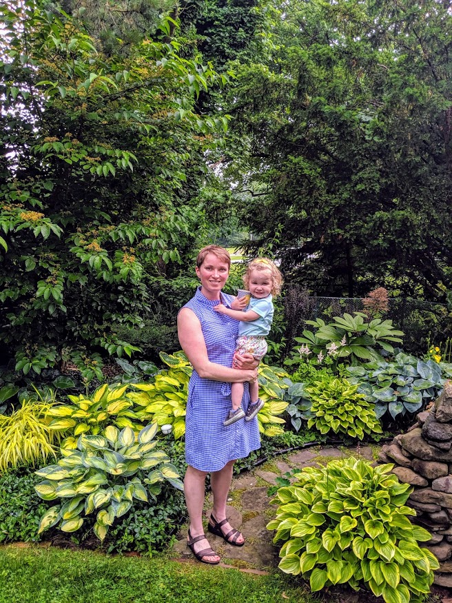 woman and child in a green garden