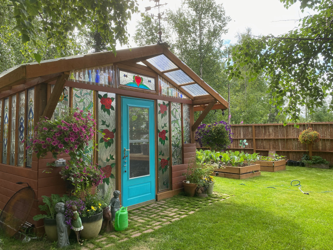 greenhouse next to two raised beds