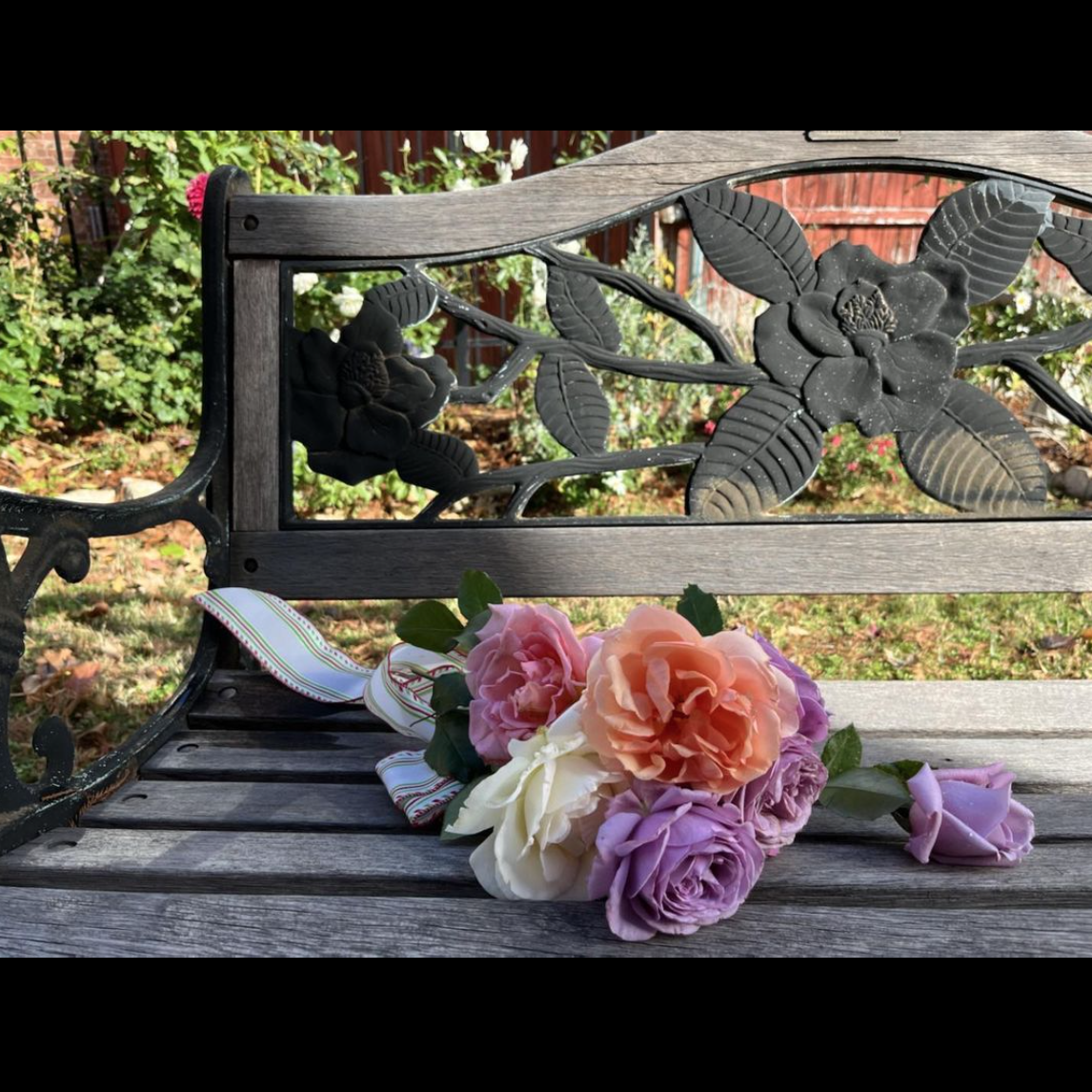 bouquet of roses on a garden bench