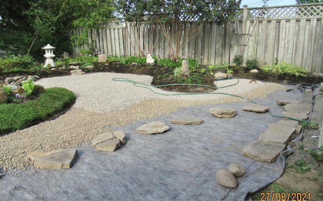 gravel being laid in Japanese dry garden 