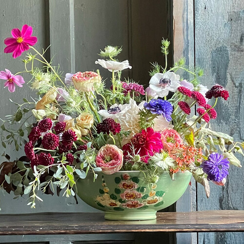 floral arrangement in green bowl