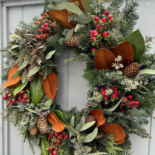 wreath with red berries and magnolia leaves