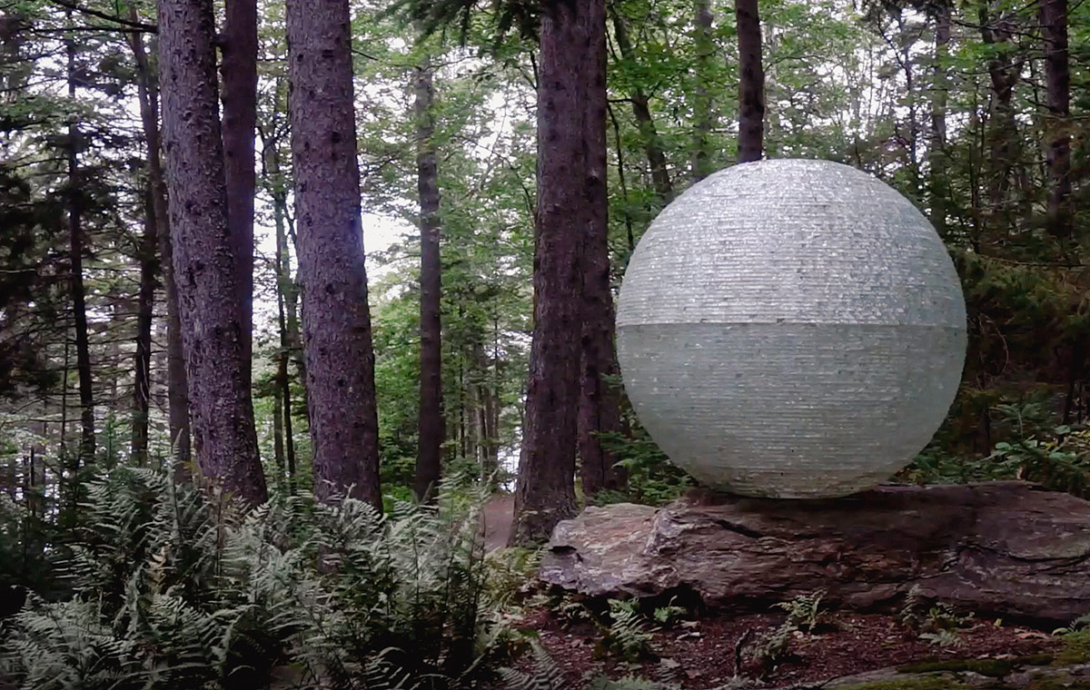 large glass orb in forest