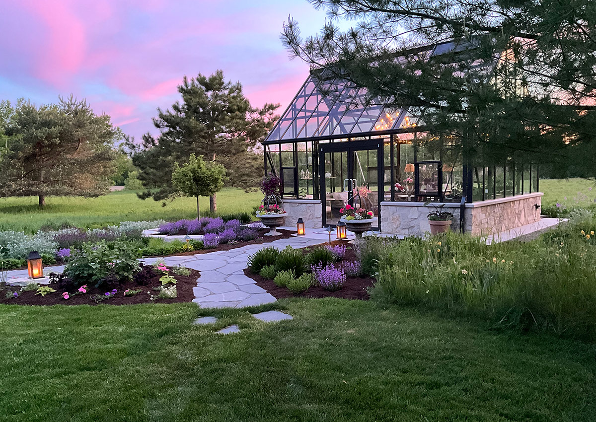 glass greenhouse with gardens in front