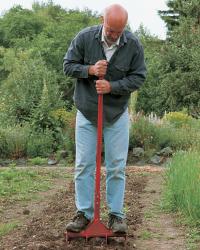 thrust deep spader into the ground, and stand on the crossbar.